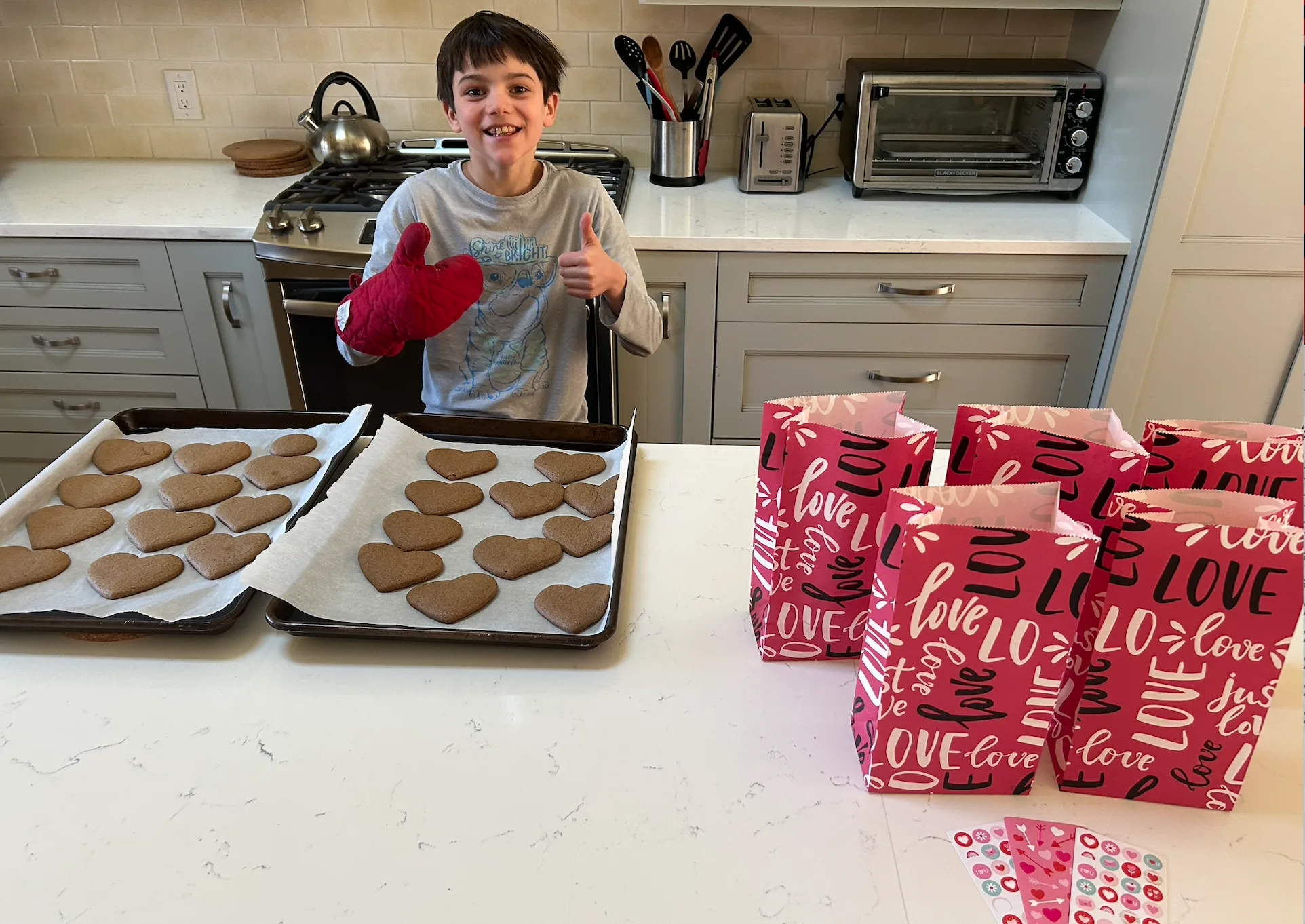 Aiden baking heart-shaped cookies for Valentine's care bags